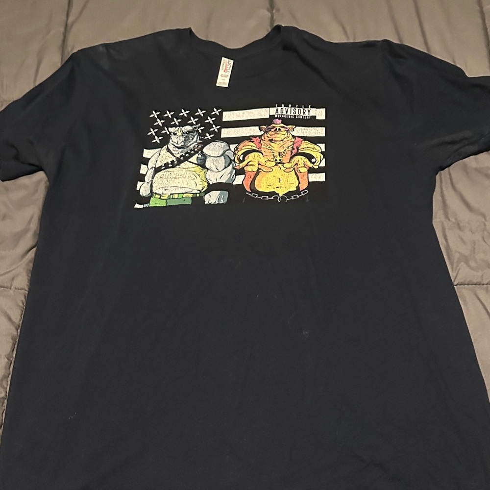 Black Graphic T-Shirt with Beebop & Rocksteady Characters. Outcast background.